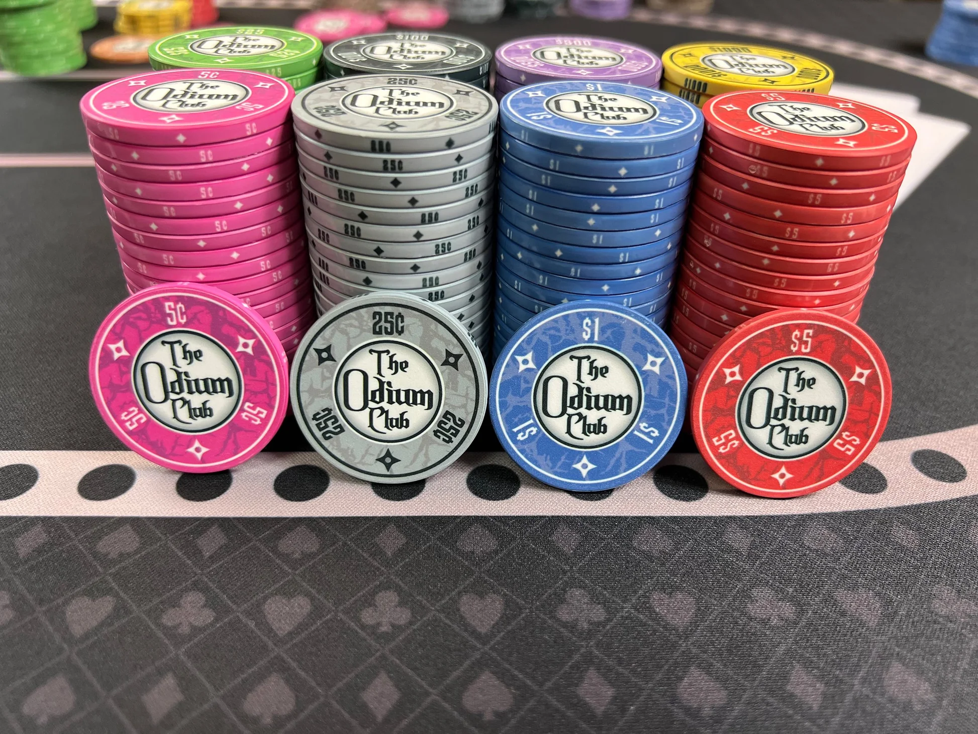 Odium-Club-Ceramic-Poker-Chips-Front-View-Chip-Faces-Hi-Res-5-cent-pink-25-cent-gray.webp